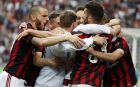 AC Milan's Nikola Kalinic, covered by his teammates, celebrates after scoring his side's third goal during the Serie A soccer match between AC Milan and Fiorentina at the San Siro stadium in Milan, Italy, Sunday, May 20, 2018. (AP Photo/Antonio Calanni)