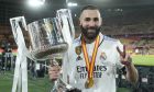 Real Madrid's Karim Benzema poses with the trophy after Madrid defeated Osasuna 2-1 in the Copa del Rey soccer final at La Cartuja stadium in Seville, Spain, Saturday, May 6, 2023. (AP Photo/Jose Breton)