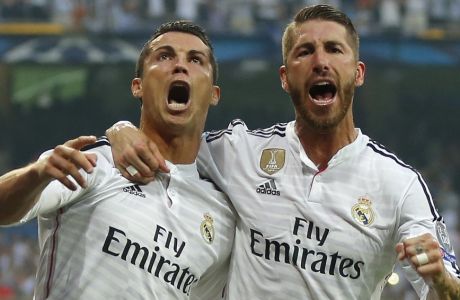 Real Madrid's Cristiano Ronaldo and teammate Sergio Ramos, right, celebrate after Ronaldo scored 1-0 during the Champions League second leg semifinal soccer match between Real Madrid and Juventus, at the Santiago Bernabeu stadium in Madrid, Wednesday, May 13, 2015. (AP Photo/Daniel Ochoa de Olza)