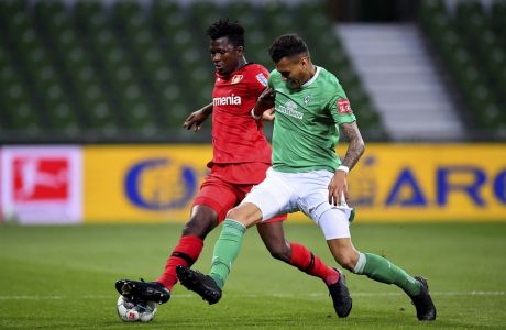 Bremen's Davie Selke, right, and Edmond Tapsoba of Leverkusen challenge for the ball during the German Bundesliga soccer match between Werder Bremen and Bayer Leverkusen 04 in Bremen, Germany, Monday, May 18, 2020. The German Bundesliga becomes the world's first major soccer league to resume after a two-month suspension because of the coronavirus pandemic. (AP Photo/Stuart Franklin, Pool)