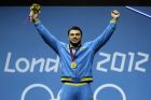 Gold medalist Oleksiy Torokhtiy of Ukraine participates in the awards presentation after the men's 105-kg weightlifting competition at the 2012 Summer Olympics, Monday, Aug. 6, 2012, in London. (AP Photo/Ng Han Guan)