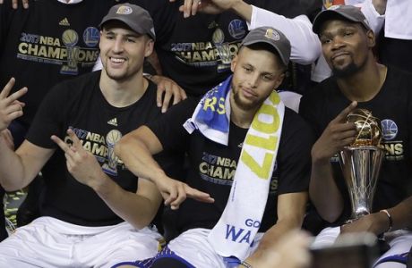 Golden State Warriors guard Klay Thompson, from left, guard Stephen Curry and forward Kevin Durant celebrate after Game 5 of basketball's NBA Finals against the Cleveland Cavaliers in Oakland, Calif., Monday, June 12, 2017. The Warriors won 129-120 to win the NBA championship. (AP Photo/Marcio Jose Sanchez)