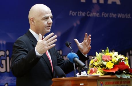 FIFA President Gianni Infantino gestures during a news conference in Hanoi, Vietnam, Thursday, Feb. 8, 2018. Infantino is on a one-day visit to Vietnam to discuss with Vietnamese leaders on how the world soccer body can further help the communist country develop its soccer. (AP Photo/Tran Van Minh)