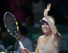 Denmark's Caroline Wozniacki celebrates after defeating Russia's Maria Sharapova in their singles match at the WTA tennis finals in Singapore,Tuesday, Oct. 21, 2014. (AP Photo/Mark Baker)