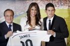 Real Madrid president Florentino Perez, left, and new Real Madrid player James Rodriguez, from Colombia, right, accompanied by his wife Daniela Ospina, pose for photographers holding his new shirt during his official presentation at the Santiago Bernabeu stadium in Madrid, Spain, Tuesday, July 22, 2014, after signing for Real Madrid. Real Madrid have signed Rodriguez from Monaco on a six-year contract,  (AP Photo/Daniel Ochoa de Olza)