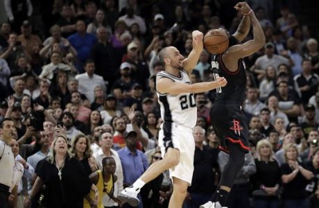 San Antonio Spurs' Manu Ginobili (20) of Argentina blocks Houston Rockets' James Harden three-point shot attempt in the final seconds of overtime of Game 5 in a second-round NBA basketball playoff series, Tuesday, May 9, 2017, in San Antonio. San Antonio won 110-107. (AP Photo/Eric Gay)
