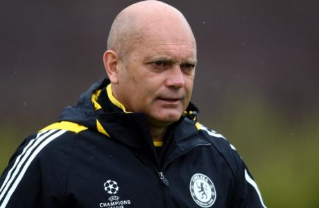FILE - In this Monday, April 27, 2009 file photo, Chelsea assistant manager Ray Wilkins walks out to a training session at their training ground, Cobham, England. With finding a job in England harder due to the influx of foreign coaches, Ray Wilkins hopes working abroad himself can revitalize his career. The former England midfielder, who was fired as Fulham assistant manager in February, has been hired on a short-term deal by Jordan.  Wilkins told The Associated Press on Monday, Sept. 8, 2014,  that "it's always extremely difficult when you are out of work in England to be re-employed. (AP Photo/Tom Hevezi, File)