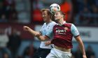 West Ham's Andy Caroll, right, heads the ball under pressure from Tottenham's Harry Kane during their English Premier League soccer match between West Ham United and Tottenham Hotspur at the Boleyn stadium in London Saturday, May  3  2014. (AP Photo/Alastair Grant)