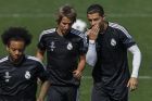 Real Madrid's Cristiano Ronaldo from Portugal, right, talks to Coentrao during a training session at the Valdebebas Stadium in Madrid, Spain, Tuesday, May 12, 2015. Real Madrid will play against Juventus in a second leg semifinal Champions League soccer match on Wednesday. (AP Photo/Daniel Ochoa de Olza)