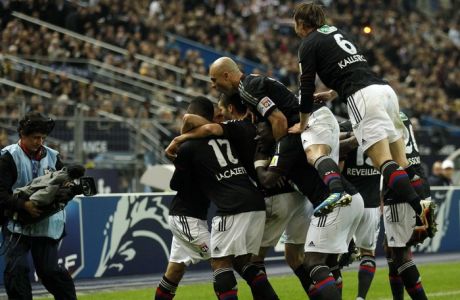 Olympique Lyon's players react after Lisandro Lopez scored against Quevilly during their French Cup final soccer match at the Stade de France Stadium in Saint-Denis, near Paris, April 28, 2012. REUTERS/Benoit Tessier  (FRANCE - Tags: SPORT SOCCER)