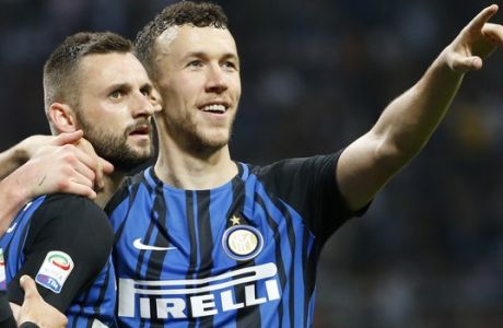 Inter Milan's Marcelo Brozovic celebrates with teammate Inter Milan's Ivan Perisic, right, after scoring his side's third goal during an Italian Serie A soccer match between Inter Milan and Cagliari, at the San Siro stadium in Milan, Italy, Tuesday, April 17, 2018. (AP Photo/Antonio Calanni)