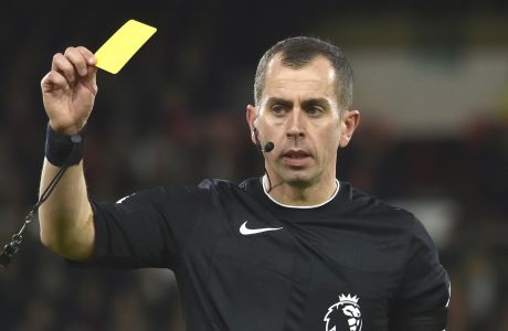 Referee Peter Bankes shows a yellow card to Chelsea's Kai Havertz during the English Premier League soccer match between Nottingham Forest and Chelsea at City ground in Nottingham, England, Sunday, Jan. 1, 2023. (AP Photo/Rui Vieira)