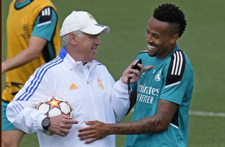 Real Madrid's head coach Carlo Ancelotti, left, talks with Real Madrid's Eder Militao during a Media Opening day training session in Madrid, Spain, Tuesday, May 24, 2022. Real Madrid will play Liverpool in Saturday's Champions League soccer final in Paris. (AP Photo/Manu Fernandez)