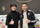 Germany's forward Lukas Podolski, right, and national head coach Joachim Loew show thumbs up at a press conference prior the friendly soccer match between Germany and England in Dortmund, Germany, Tuesday, March 21, 2017. Podolski will play his last match for the national team against England on Wednesday. (AP Photo/Martin Meissner)