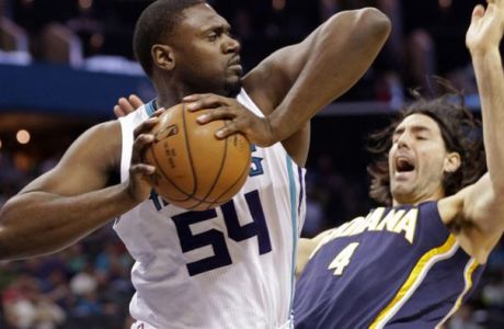 Charlotte Hornets' Jason Maxiell (54) grabs a rebound over Indiana Pacers' Luis Scola (4) during the first half of an NBA basketball game in Charlotte, N.C., Sunday, Feb. 8, 2015. (AP Photo/Chuck Burton)