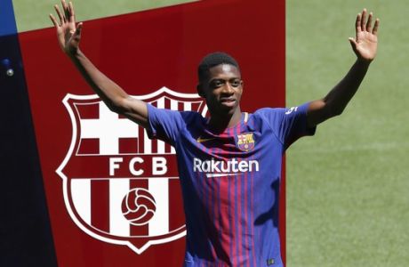 FILE  - In this Monday, Aug. 28, 2017 file photo, French soccer player Ousmane Dembele gestures during official presentation at the Camp Nou stadium in Barcelona, Spain. Dembele, the 20-year-old France striker signed by Barcelona to replace Neymar is expected to make his debut in the Catalan derby against Espanyol on Saturday, Sept. 9, 2017. (AP Photo/Manu Fernandez, File)