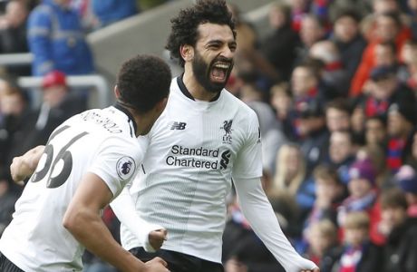 Liverpool's Mohamed Salah reacts and celebrates after scoring his sides second goal of the game during their English Premier League soccer match between Crystal Palace and Liverpool at Selhurst Park stadium in London, Saturday, March, 31, 2018. Liverpool won the match 2-1. (AP Photo/Alastair Grant)