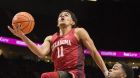 FILE - In this Nov. 23, 2017, file photo, Oklahoma guard Trae Young, left, scores a basket as he is guarded by Arkansas guard Daryl Macon, right, during the first half in an NCAA college basketball game at the Phil Knight Invitational Tournament in Portland, Ore. Young is a possible pick in Thursday's NBA Draft.(AP Photo/Troy Wayrynen, File)