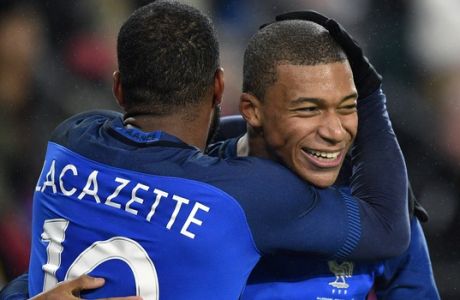 France's scorer Alexandre Lacazette, left, and his teammate Kylian Mbappe, right, celebrate their side's 2nd goal during an international friendly soccer match between Germany and France in Cologne, Germany, Tuesday, Nov. 14, 2017. (AP Photo/Martin Meissner)