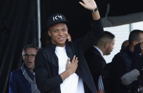 France soccer team player Kylian Mbappe waves to crowd during a visit at the Leo Lagrange stadium in his hometown of Bondy, east of Paris, Wednesday, Oct. 17, 2018. (AP Photo/Thibault Camus)