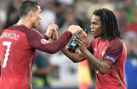 Portugal's Cristiano Ronaldo, left, congratulates Renato Sanches who scored their first goal during the Euro 2016 quarterfinal soccer match between Poland and Portugal, at the Velodrome stadium in Marseille, France, Thursday, June 30, 2016. (AP Photo/Martin Meissner)