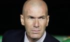 FILE - In this In this file photo dated March 8, 2020, Real Madrid's head coach Zinedine Zidane sits at the bench during La Liga soccer match in Seville, Spain. Zinedine Zidane is again stepping down as Real Madrid coach. The club says the Frenchman is leaving his job. It comes four days after a season in which Madrid failed to win a title for the first time in more than a decade. (AP Photo/Miguel Morenatti, File)