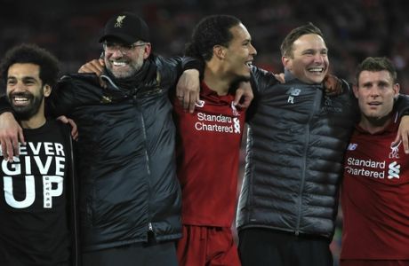 Liverpool's Mohamed Salah, Manager Jurgen Klopp, Virgil van Dijk, Assistant manager Pepijn Lijnders and James Milner, from left, celebrate after the Champions League Semi Final, second leg soccer match between Liverpool and Barcelona at Anfield, Liverpool, England, Tuesday, May 7, 2019. Liverpool won the match 4-0 to overturn a three-goal deficit to win the match 4-3 on aggregate. (Peter Byrne/PA via AP)