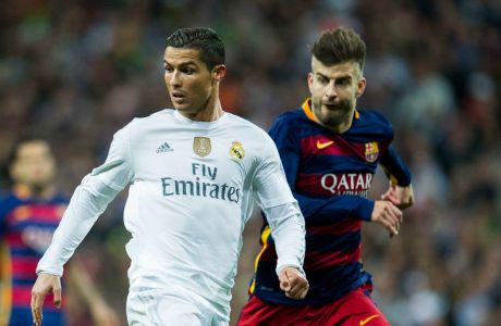MADRID, SPAIN - NOVEMBER 21:  Cristiano Ronaldo of Real Madrid duels for the ball with Gerard Pique of Barcelona during the La Liga match between Real Madrid CF and FC Barcelona at Estadio Santiago Bernabeu on November 21, 2015 in Madrid, Spain.  (Photo by Juan Manuel Serrano Arce/Getty Images)