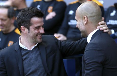 Hull City manager Marco Silva, left, greets Manchester City manager Pep Guardiola before their English Premier League match at the Etihad Stadium, Manchester, England, Saturday, April 8, 2017. (Dave Thompson/PA via AP)