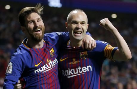 Barcelona's Andres Iniesta, right, celebrates withLionel Messi after scoring his side's fourth goal during the Copa del Rey final soccer match between Barcelona and Sevilla at the Wanda Metropolitano stadium in Madrid, Spain, Saturday, April 21, 2018. (AP Photo/Paul White)