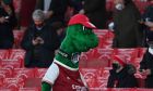 The Arsenal mascot walks by as a number of home fans sit waiting for the start of an English Premier League soccer match between Arsenal and Burnley at the Emirates stadium in London, England, Sunday Dec. 13, 2020. (Laurence Griffiths/Pool via AP)