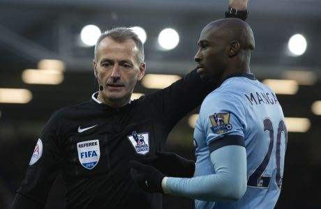 Manchester City's Eliaquim Mangala is shown a yellow card by referee Martin Atkinson during the English Premier League soccer match between Everton and Manchester City at Goodison Park Stadium, Liverpool, England, Saturday Jan. 10, 2015. (AP Photo/Jon Super)  