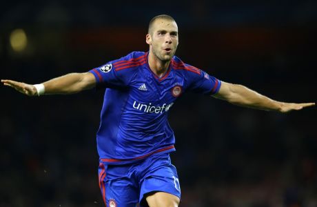 Olympiakos' Pajtim Kasami celebrates after the Champions League Group F soccer match between Arsenal and Olympiakos at Emirates stadium in London Tuesday, Sept. 29, 2015. Olympiakos won the match 3-2. (AP Photo/Kirsty Wigglesworth) 