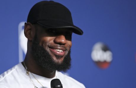 Cleveland Cavaliers forward LeBron James smiles during a news conference following Game 4 of basketball's NBA Finals against the Golden State Warriors, early Saturday, June 9, 2018, in Cleveland. The Warriors defeated the Cavaliers 108-85 to sweep the series and take the title. (AP Photo/Carlos Osorio)