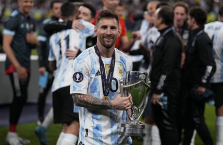 Argentina's Lionel Messi holds a trophy as he celebrates after winning the Finalissima soccer match between Italy and Argentina at Wembley Stadium in London , Wednesday, June 1, 2022. Argentina won 3-0. (AP Photo/Matt Dunham)