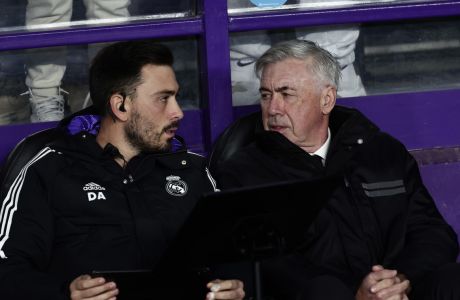 Real Madrid's head coach Carlo Ancelotti, right, speaks with his son, assistant coach Davide Ancelotti before the start of a Spanish La Liga soccer match between Valladolid and Real Madrid at the Jose Zorrilla stadium in Valladolid, Spain, Friday, Dec. 30, 2022. (AP Photo/Pablo Garcia)