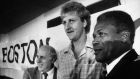 Boston, MA - 9/28/1983: From left, Boston Celtics general manager Red Auerbach, Celtics players Larry Bird, and coach K.C. Jones shake hands during a press conference to announce that Bird will finish his career with the Celtics after signing a seven-year contract on Sept. 28, 1983.  (Stan Grossfeld/Globe Staff) --- BGPA Reference: 170106_MJ_002