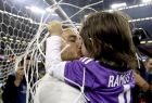 Real Madrid's Sergio Ramos celebrates with one of his children after winning the Champions League Final soccer match between Juventus and Real Madrid at the Millennium Stadium in Cardiff, Wales, Saturday, June 3, 2017. (Nick Potts/PA via AP)