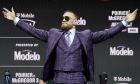 Conor McGregor motions to the crowd during a news conference for a UFC 264 mixed martial arts bout Thursday, July 8, 2021, in Las Vegas. McGregor is scheduled to fight Dustin Poirier in a lightweight bout Saturday in Las Vegas (AP Photo/John Locher)