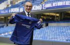 Maurizio Sarri, the new Chelsea team manager, holds up a shirt on the pitch as he is introduced to the media at Stamford Bridge stadium in London, Wednesday, July 18, 2018. (AP Photo/Kirsty Wigglesworth)
