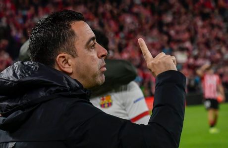 Barcelona's head coach Xavi Hernandez gives instructions to his players prior a Spanish La Liga soccer match between Athletic Bilbao and Barcelona at the San Mames stadium in Bilbao, Spain, on Sunday, March 3, 2024. (AP Photo/Alvaro Barrientos)