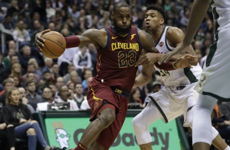 Cleveland Cavaliers' LeBron James drives past Milwaukee Bucks' Giannis Antetokounmpo during the first half of an NBA basketball game Tuesday, Dec. 19, 2017, in Milwaukee. (AP Photo/Morry Gash)