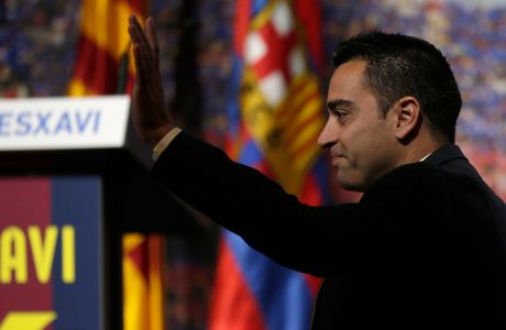 FC Barcelona Xavi Hernandez waves to the crowd during his farewell event at the Camp Nou stadium in Barcelona, Spain, Wednesday, June 3, 2015.  FC Barcelona midfielder Xavi Hernandez says he will leave the Catalan club after 17 trophy-laden seasons in which he set club records for appearances and titles won. The 35-year-old Xavi says he will cut his contract short by one year and leave after this season to go play for Qatari club Al-Sadd on a two-year contract. (AP Photo/Manu Fernandez)
