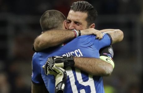 Italy goalkeeper Gianluigi Buffon is hugged by teammate Leonardo Bonucci after their team was eliminated in the World Cup qualifying play-off second leg soccer match between Italy and Sweden, at the Milan San Siro stadium, Italy, Monday, Nov. 13, 2017. (AP Photo/Luca Bruno)