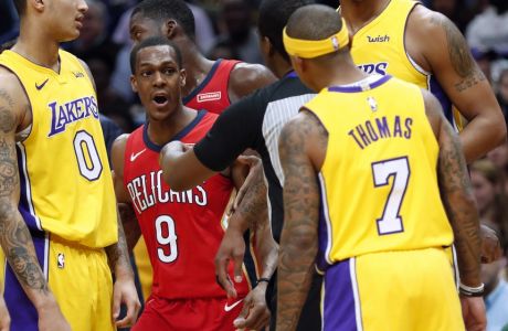 New Orleans Pelicans guard Rajon Rondo (9) and Los Angeles Lakers guard Isaiah Thomas (7) are separated by an official during the first half of an NBA basketball game in New Orleans, Wednesday, Feb. 14, 2018. Both players were ejected. (AP Photo/Gerald Herbert)