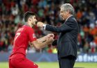 Portugal coach Fernando Santos, right, congratulates goal scorer Goncalo Guedes as they celebrate after defeating the Netherlands 1-0 in the UEFA Nations League final soccer match at the Dragao stadium in Porto, Portugal, Sunday, June 9, 2019. (AP Photo/Armando Franca)