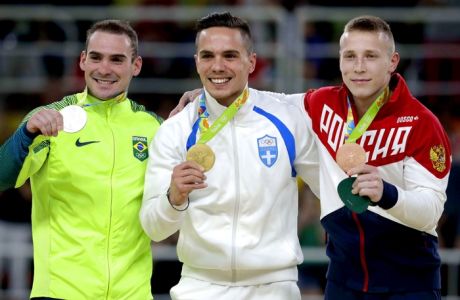 Gold medalist Greece's Eleftherios Petrounias center, silver medallist Brazil's Arthur Zanetti, left, and bronze medallist Russia's Denis Abliazin right, display their medals for the rings during the artistic gymnastics men's apparatus final at the 2016 Summer Olympics in Rio de Janeiro, Brazil, Monday, Aug. 15, 2016. (AP Photo/Julio Cortez)