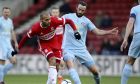 Middlesbrough's Martin Braithwaite, left, and Sunderland's Marc Wilson in action during the FA Cup, third round match at the Riverside Stadium in Middlesbrough, England, Saturday Jan. 6, 2018. (Richard Sellers/PA via AP)