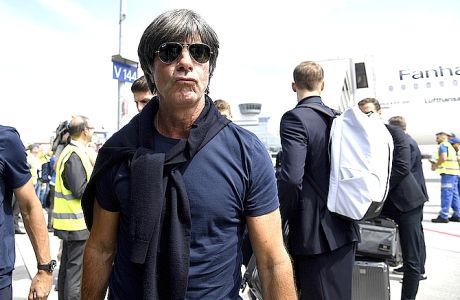 Head coach Joachim Loew leaves a plane in Frankfurt, Germany, Thursday, June 28, 2018, one day after the German team was eliminated from the soccer World Cup in Russia. (Ina Fassbender/dpa via AP)
