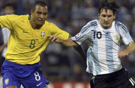 Brazil's Gilberto Silva, left, fights for the ball with Argentina's Lionel Messi during a 2010 World Cup qualifying soccer game in Rosario, Argentina, Saturday, Sept. 5, 2009. (AP Photo/Ezequiel Pontoriero)